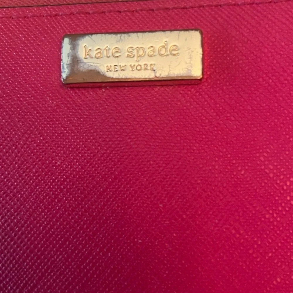 Kate Spade Newbury Lane Neda Wallet in Bougainvillea (pink).